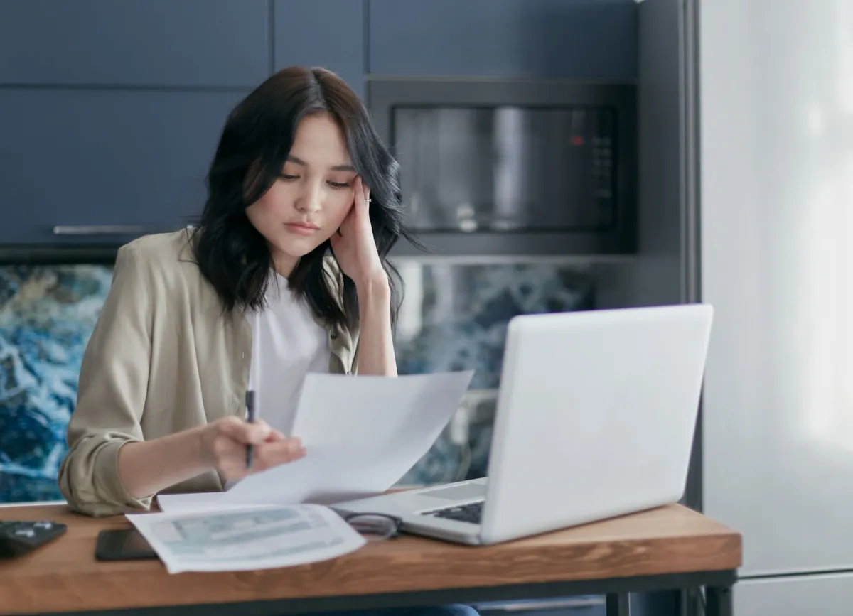 Business owners preparing loan application documents with an adviser