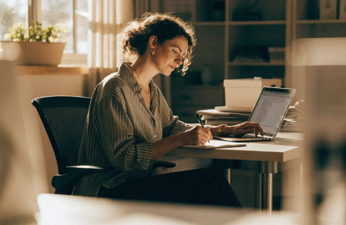 Business owner calmly reviewing finances at an organised desk