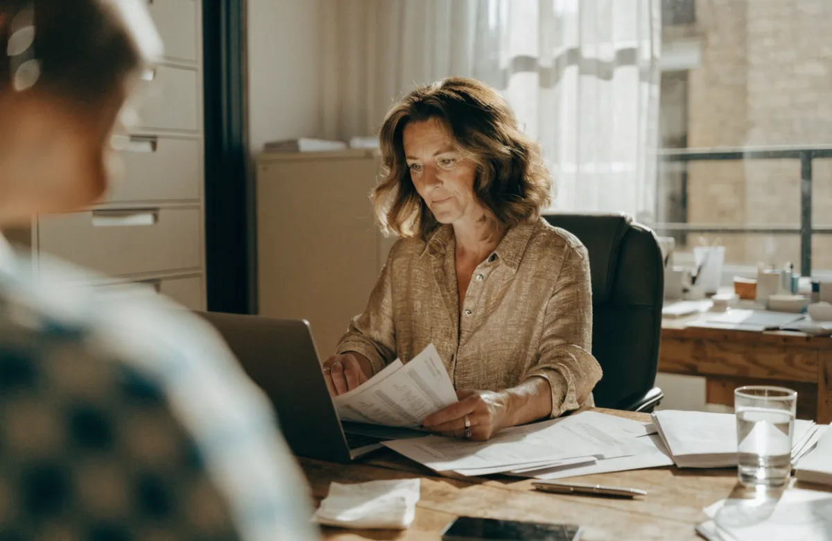 Business owner reviewing invoices on a laptop