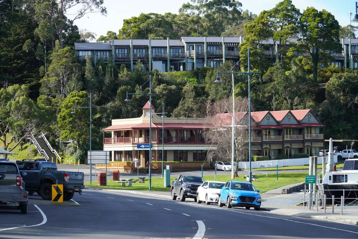 Cars parked along a small-town street with heritage buildings