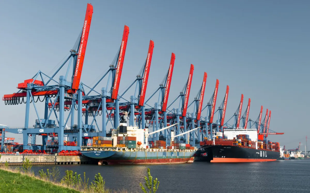 Container ships being worked by gantry cranes at a port terminal