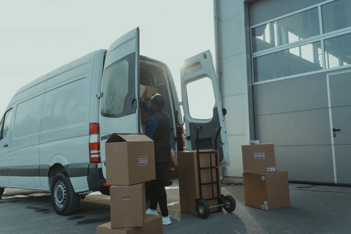 Courier collecting packages from a delivery van