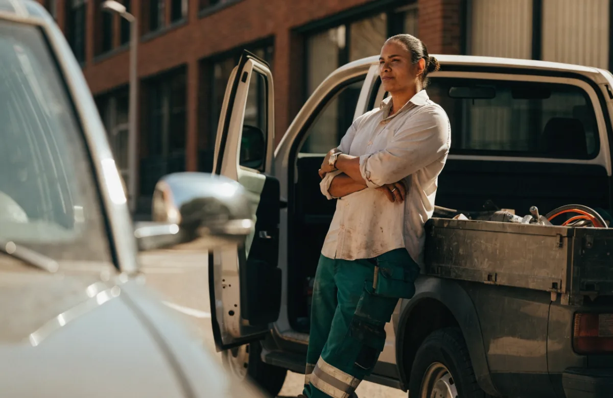 Tradesperson standing beside their work ute